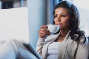 Woman drinking coffee at home