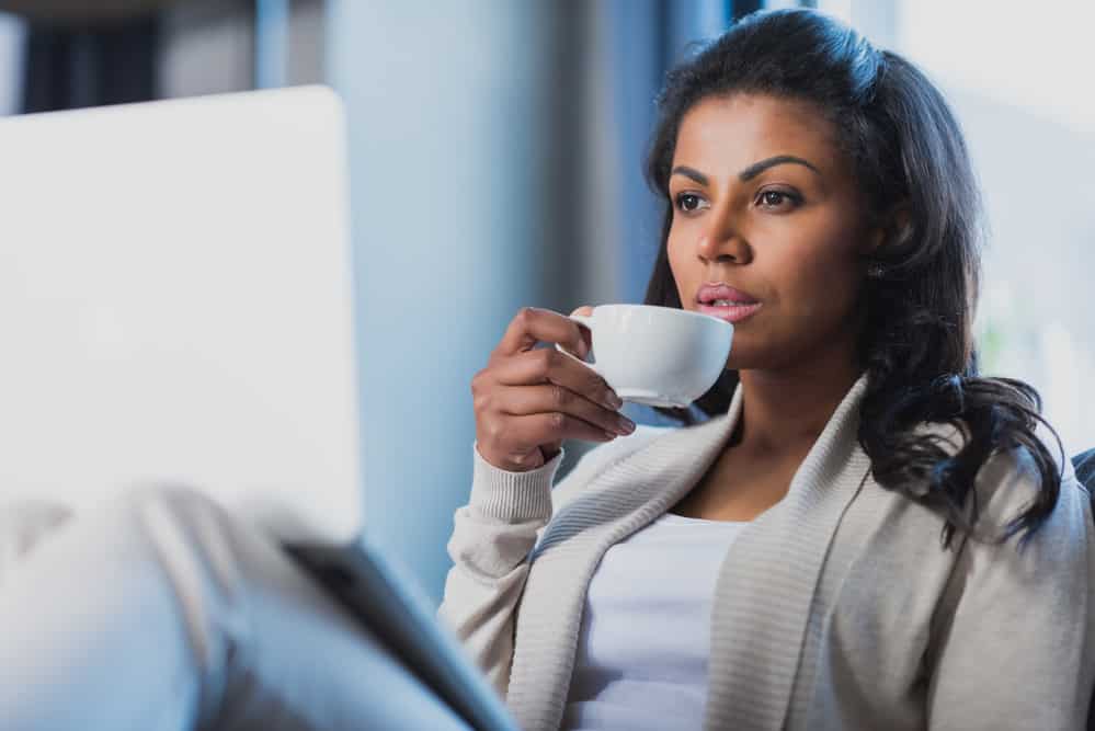 Woman drinking coffee at home