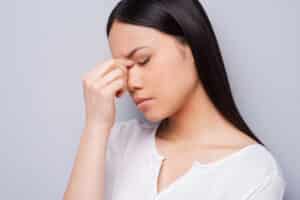 close-up of young woman with headache