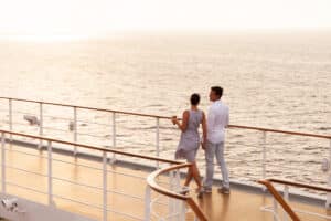 Happy young couple on deck of cruise ship