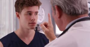 Young man receiving a concussion test at doctor office